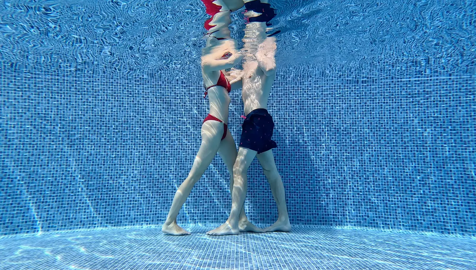Erika and Martin practicing a tango step underwater in the pool